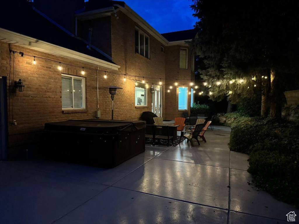 Patio at night with a hot tub