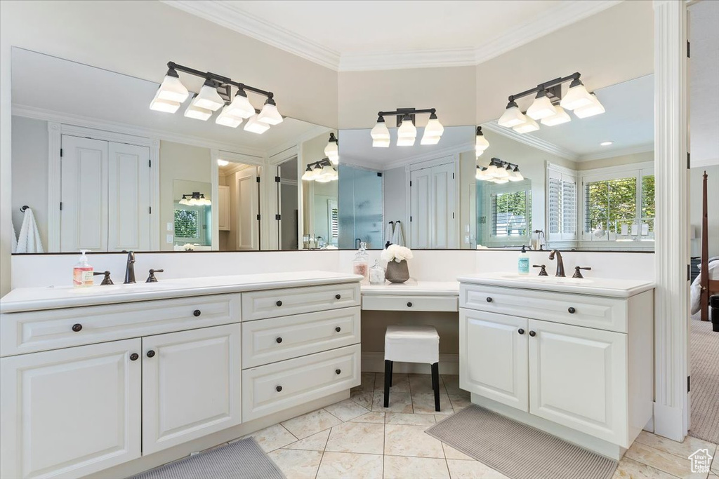 Bathroom featuring vanity, crown molding, and tile patterned flooring