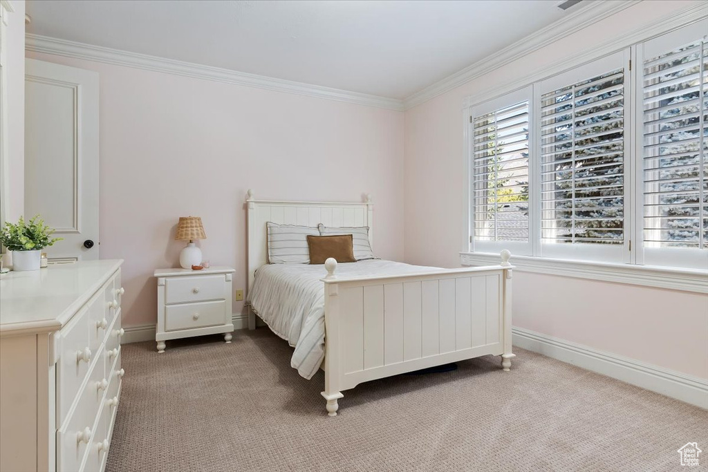 Carpeted bedroom featuring ornamental molding