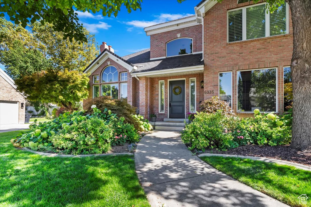 View of front of house featuring a front yard and a garage