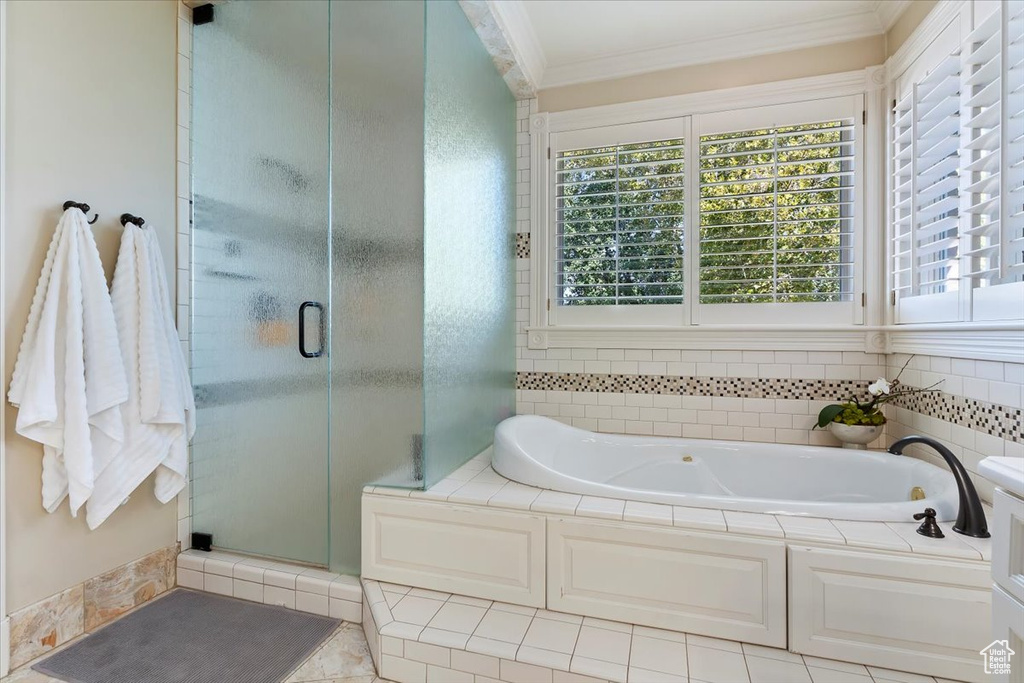 Bathroom featuring independent shower and bath, tile patterned floors, and crown molding