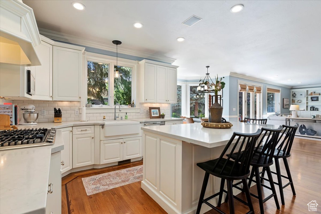 Kitchen featuring plenty of natural light, decorative light fixtures, and sink