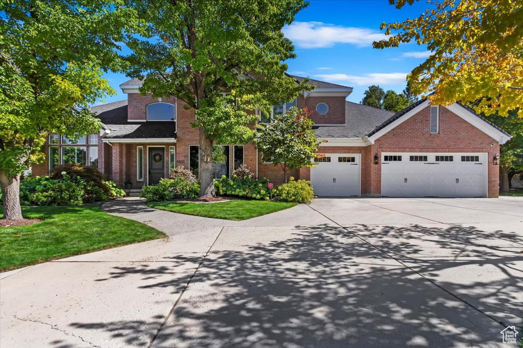 View of front of home with a garage and a front yard