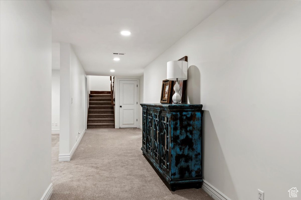 Hallway with light colored carpet