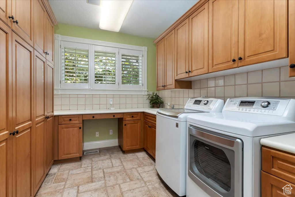 Laundry room with cabinets and washer and dryer