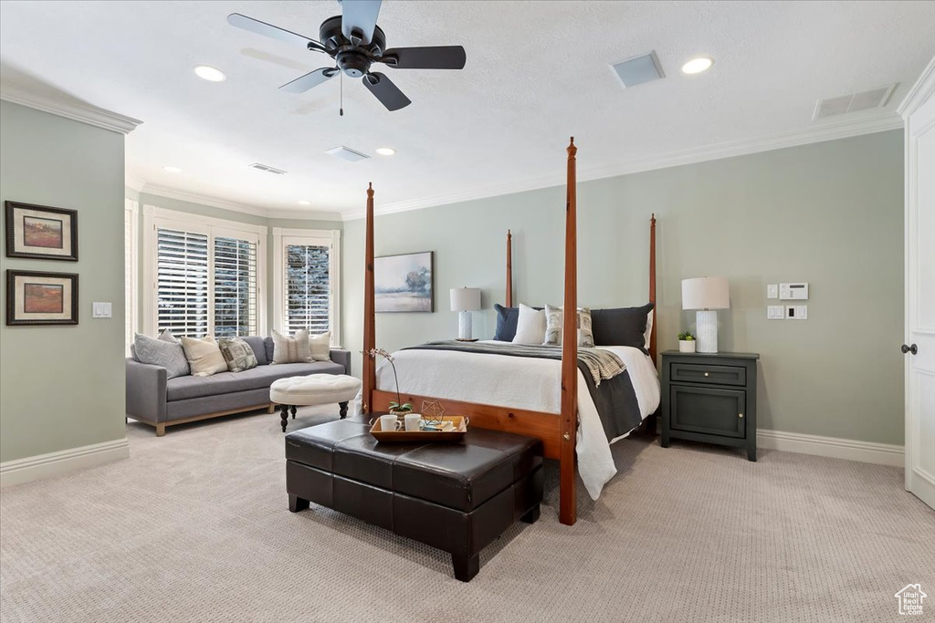 Carpeted bedroom with crown molding and ceiling fan