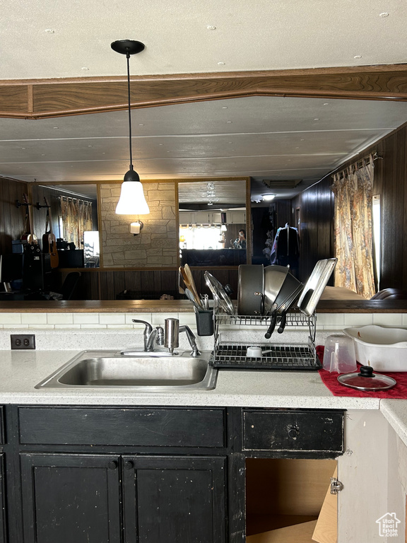 Kitchen with decorative light fixtures and sink