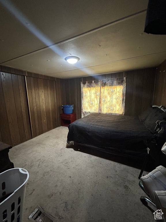 Carpeted bedroom with wooden walls