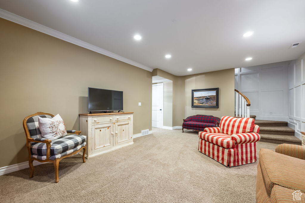 Carpeted living room featuring ornamental molding