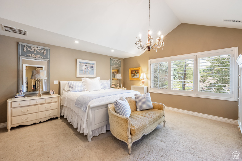 Bedroom with lofted ceiling, light carpet, and a chandelier