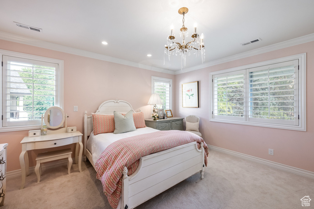 Bedroom with multiple windows, crown molding, and light carpet