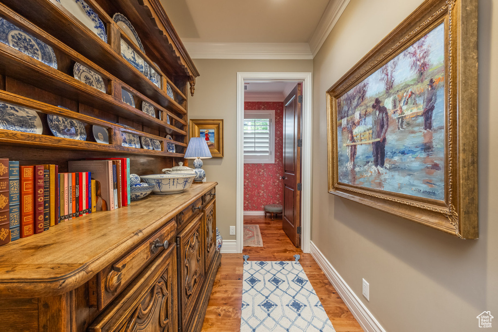 Home office featuring ornamental molding and light hardwood / wood-style floors