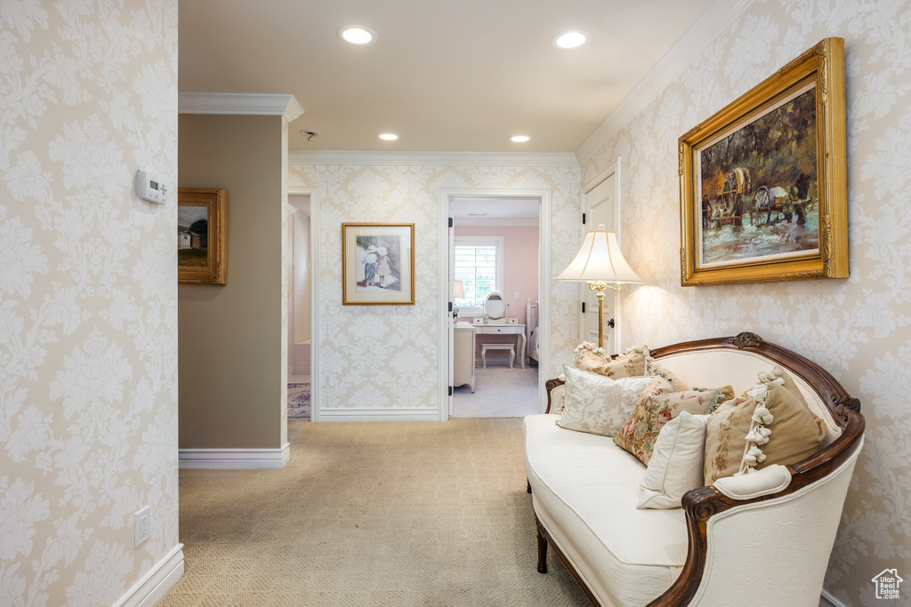 Sitting room featuring crown molding and light colored carpet