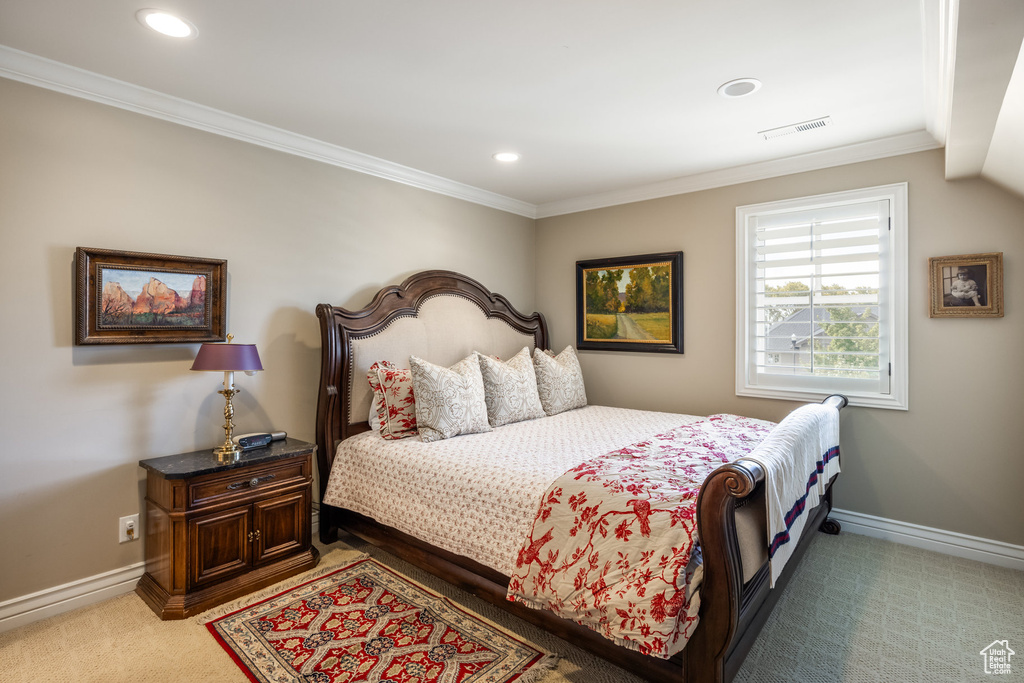 Bedroom featuring carpet floors and crown molding