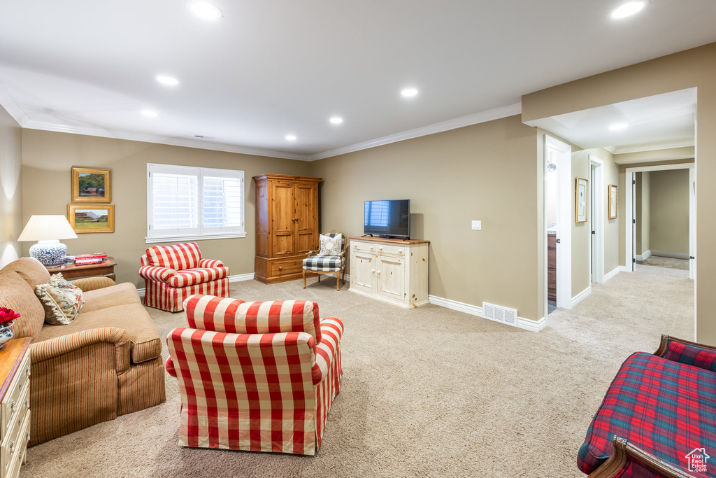 Living room with light carpet and ornamental molding