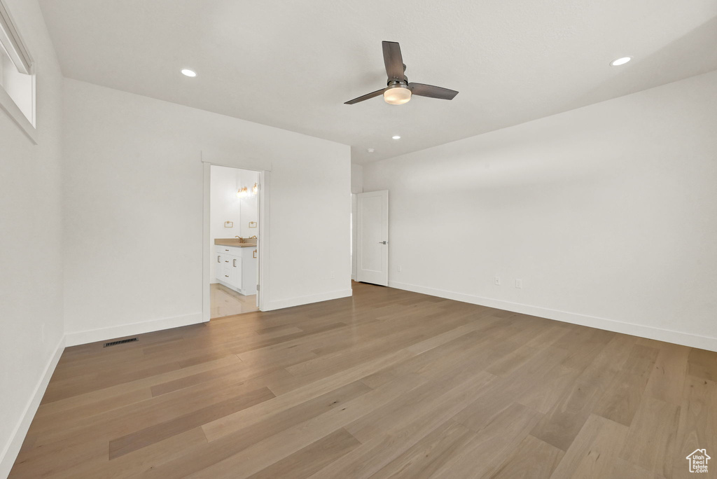 Spare room with light wood-type flooring and ceiling fan