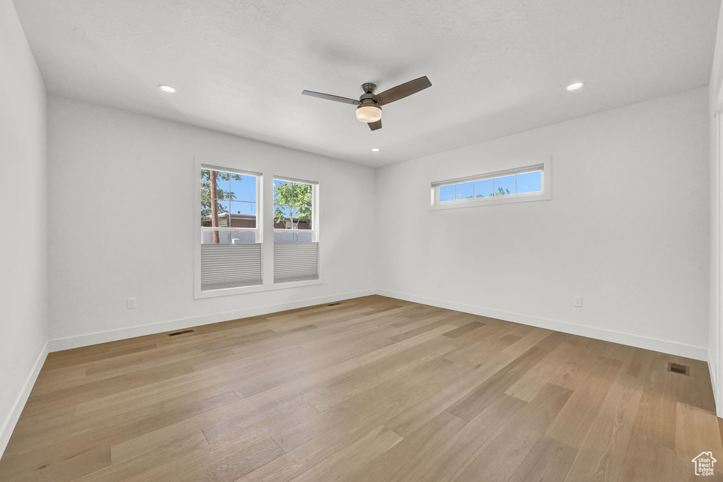 Spare room with light hardwood / wood-style floors and ceiling fan