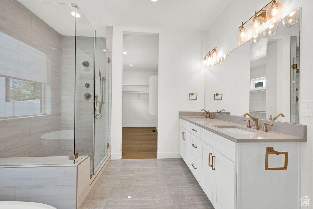 Bathroom with vanity, hardwood / wood-style floors, and an enclosed shower