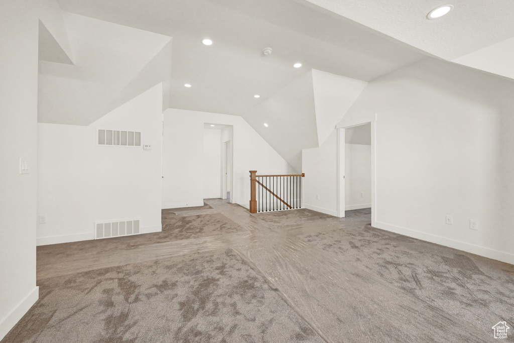 Bonus room featuring carpet floors and vaulted ceiling