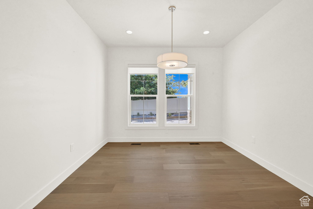 Unfurnished room featuring dark wood-type flooring