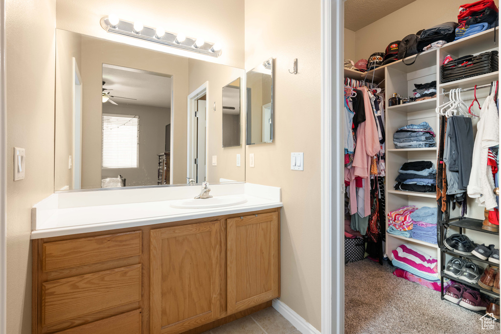 Bathroom featuring ceiling fan and vanity