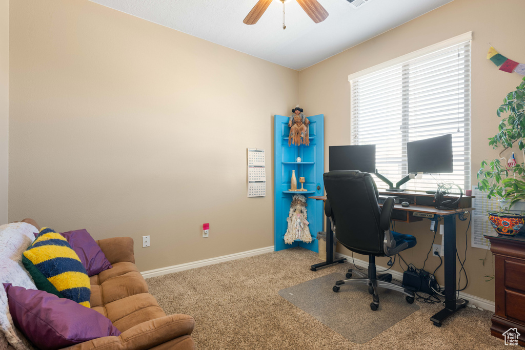 Carpeted home office with ceiling fan