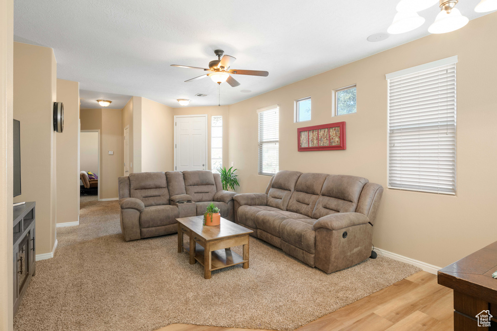 Living room featuring hardwood / wood-style floors and ceiling fan