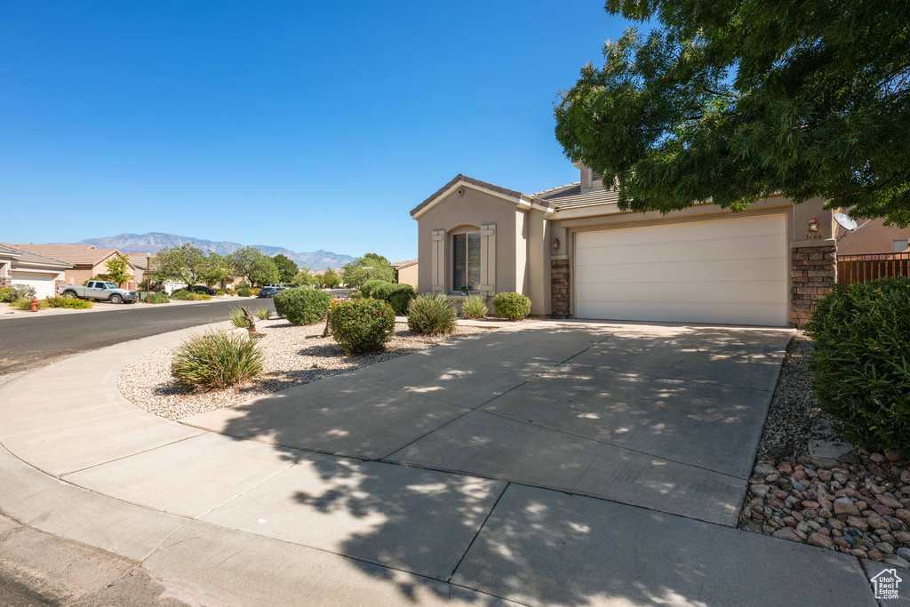 View of front of home featuring a garage and a mountain view