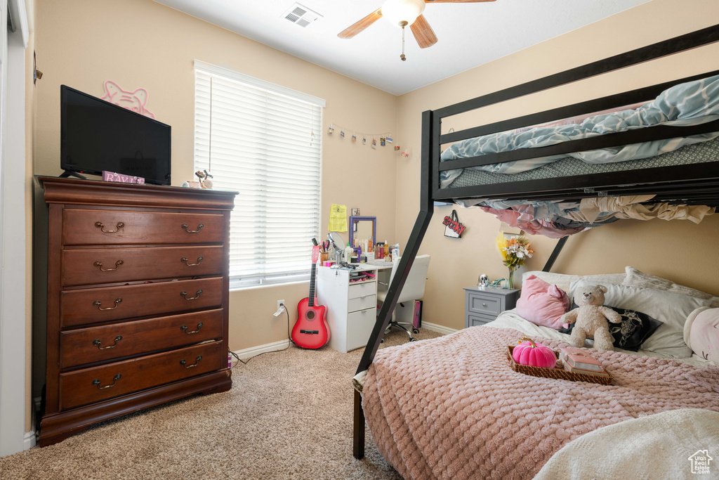 Carpeted bedroom with ceiling fan