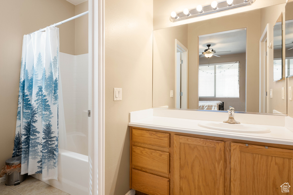 Bathroom with shower / tub combo, tile patterned flooring, ceiling fan, and vanity