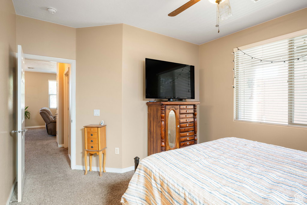 Carpeted bedroom with ceiling fan