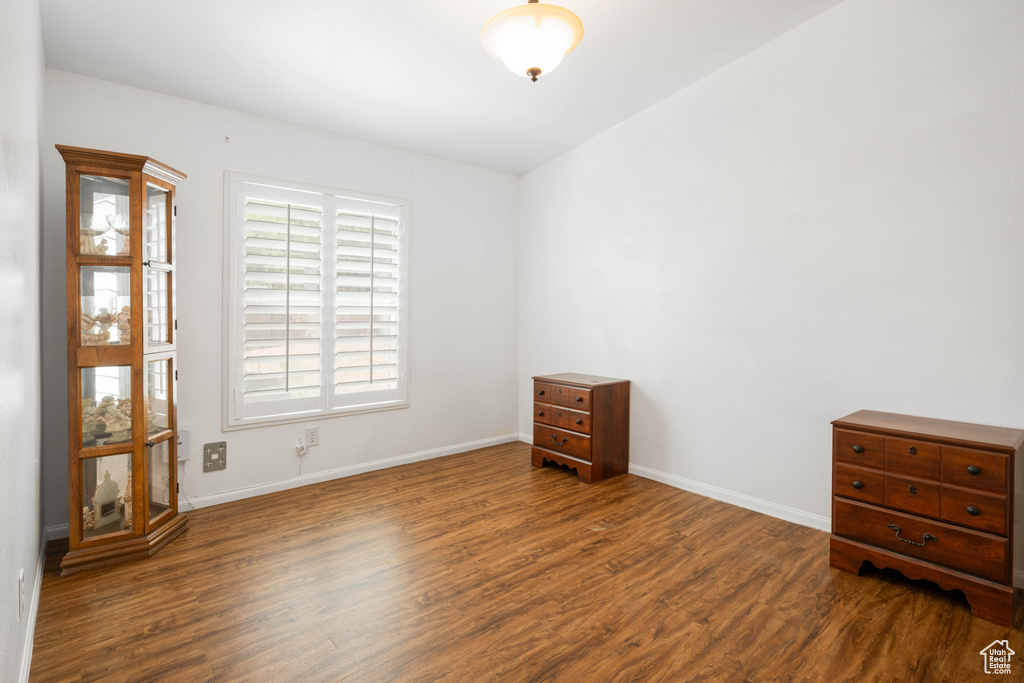 Spare room with dark wood-type flooring