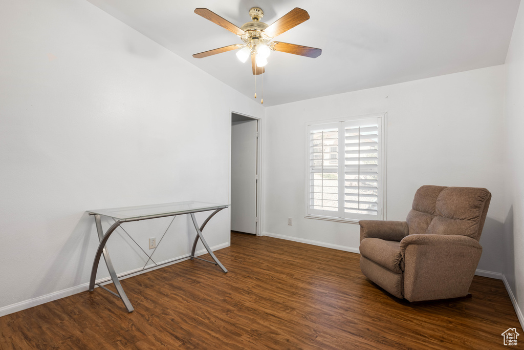 Living area featuring dark hardwood / wood-style flooring and ceiling fan