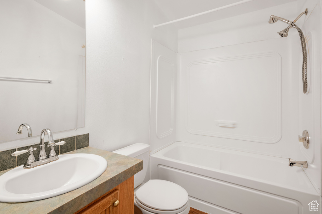 Full bathroom featuring vanity, toilet, and bathtub / shower combination