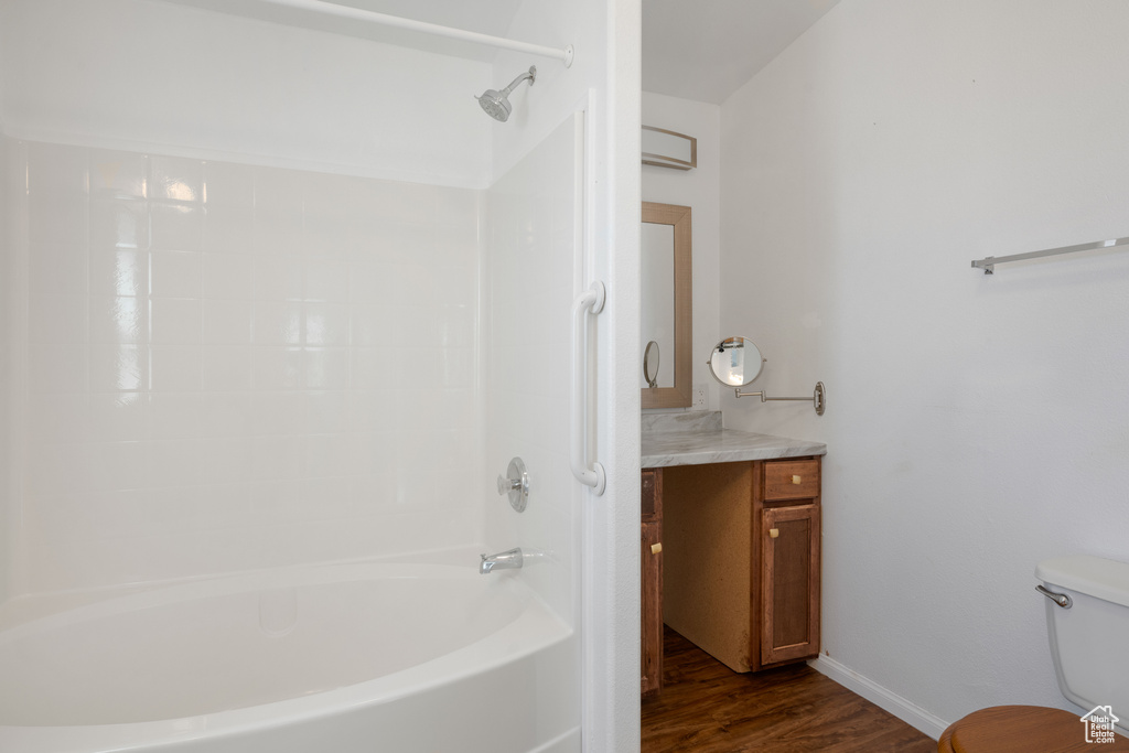 Full bathroom featuring shower / tub combination, hardwood / wood-style flooring, vanity, and toilet