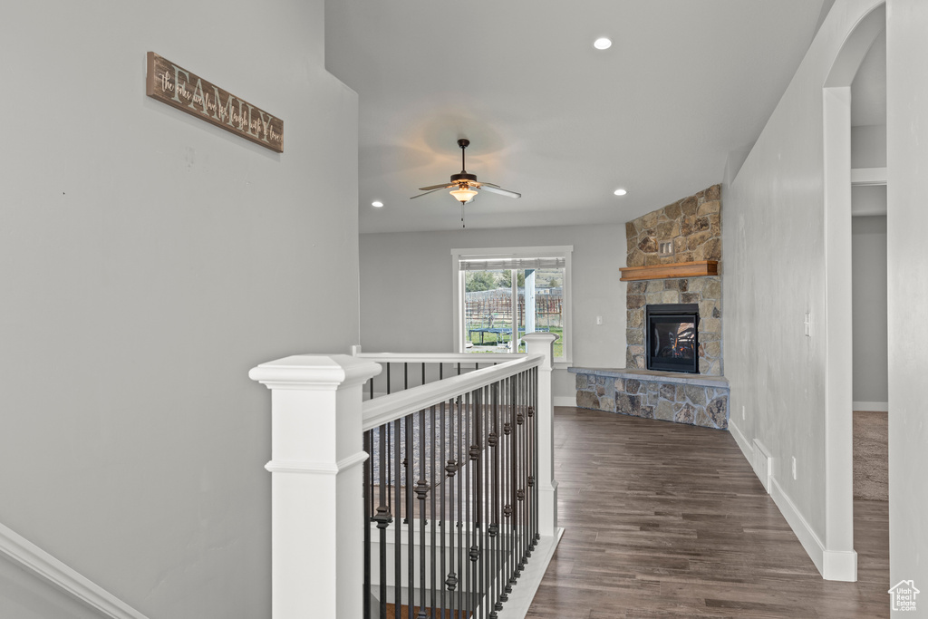 Hallway featuring an upstairs landing, wood finished floors, recessed lighting, and baseboards