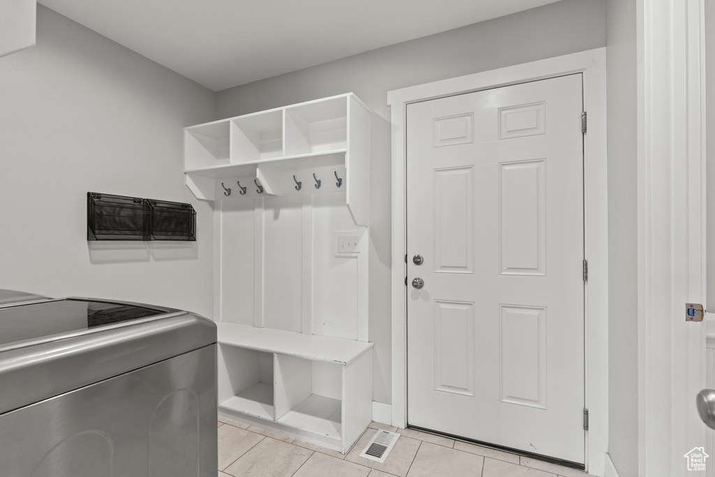 Mudroom featuring light tile patterned floors and washer / clothes dryer
