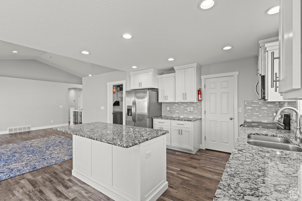 Kitchen featuring appliances with stainless steel finishes, a sink, dark wood-style flooring, white cabinets, and recessed lighting