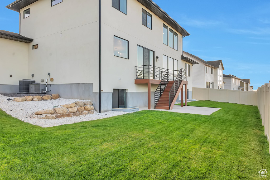 Rear view of property featuring a yard