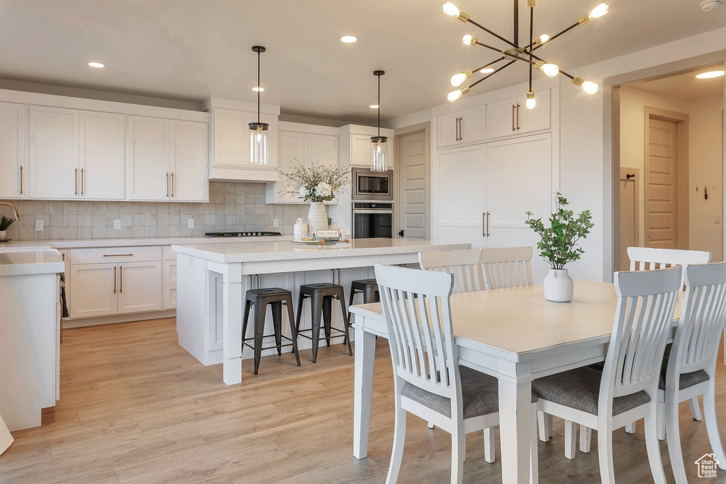 Dining area featuring light hardwood / wood-style flooring, a chandelier, and sink