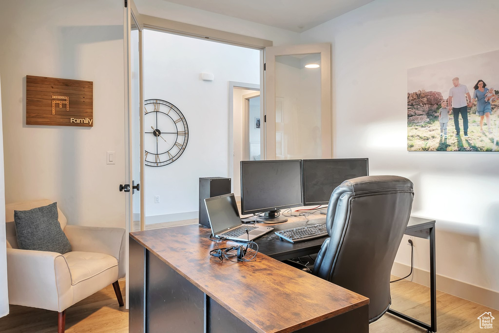 Office with light wood-type flooring