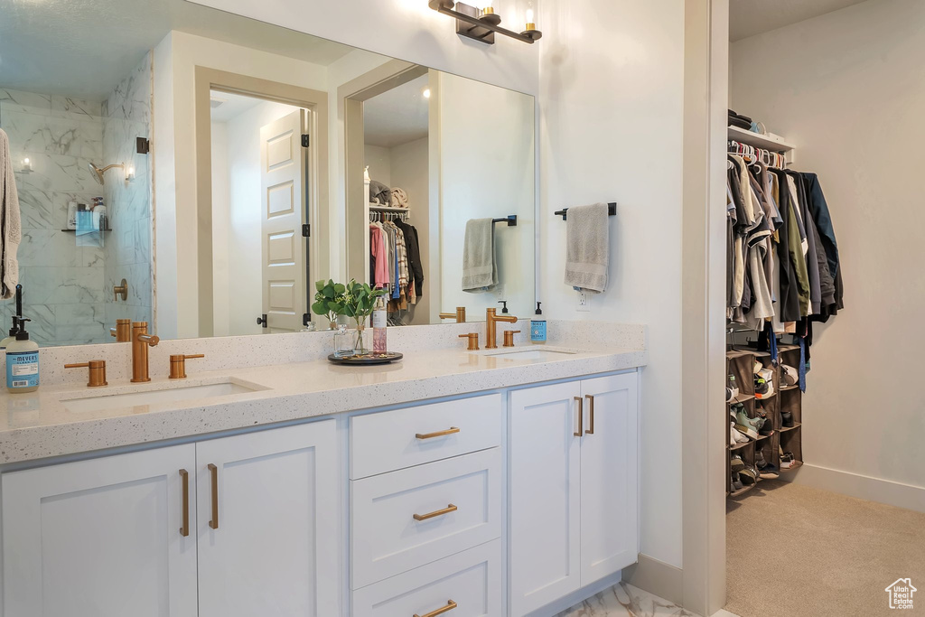 Bathroom with a shower with door and vanity