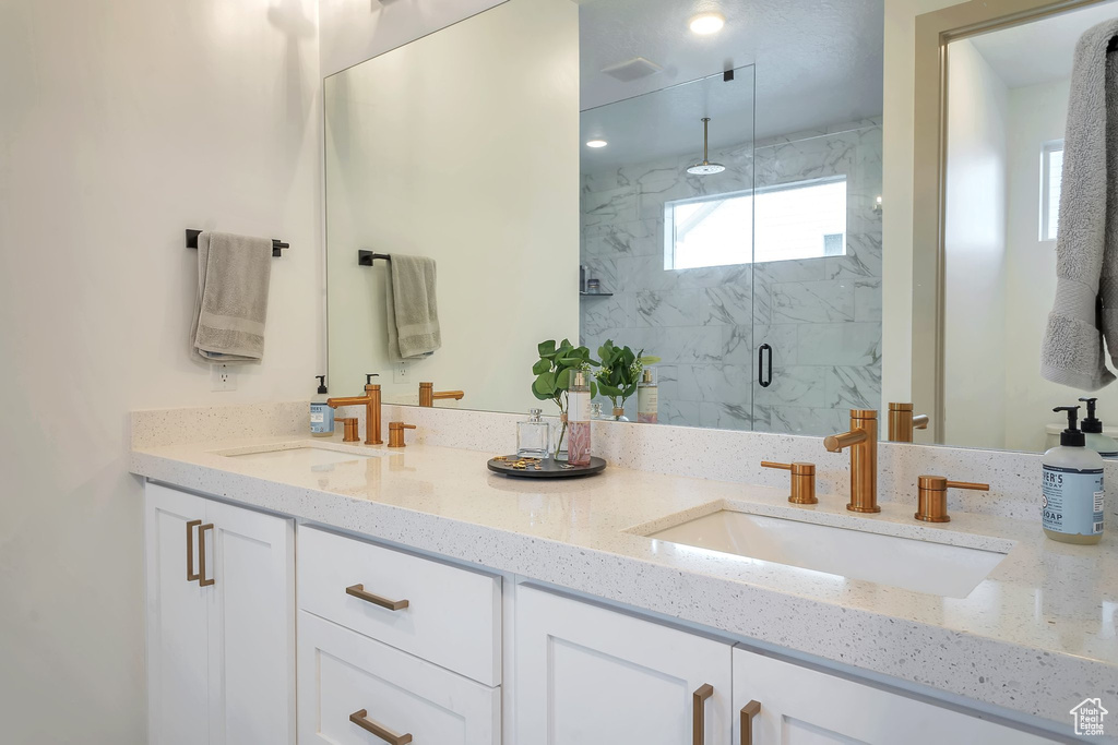 Bathroom featuring vanity and an enclosed shower