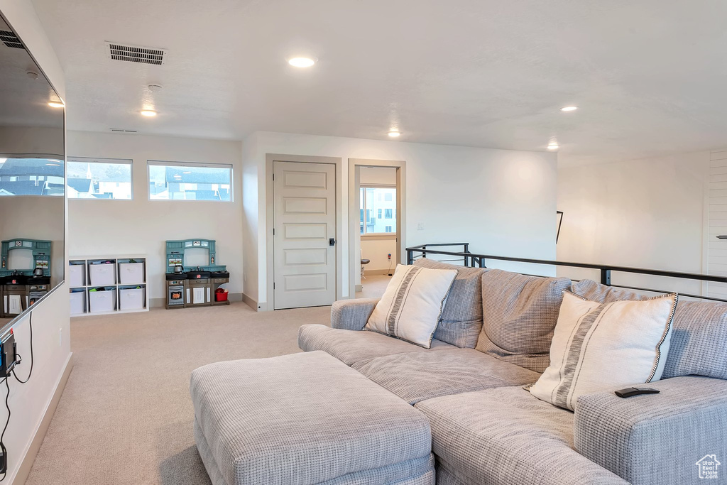 Living room with a wealth of natural light and light colored carpet