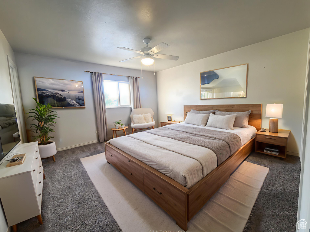 Carpeted bedroom featuring a ceiling fan and baseboards