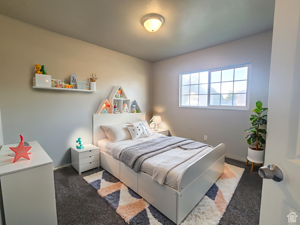 Bedroom featuring carpet floors and baseboards