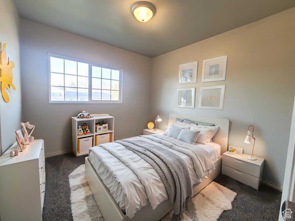 Bedroom featuring carpet floors and baseboards