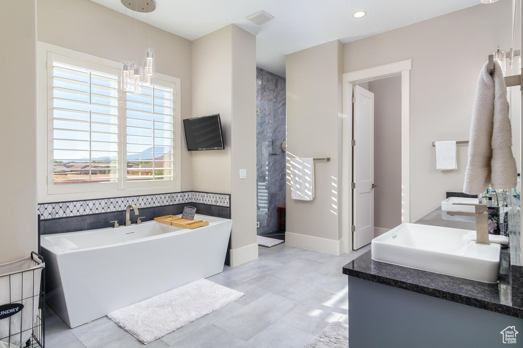 Bathroom with a bath and vanity