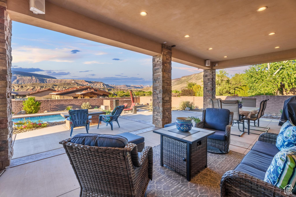 View of patio / terrace with a mountain view, a fenced in pool, and an outdoor living space