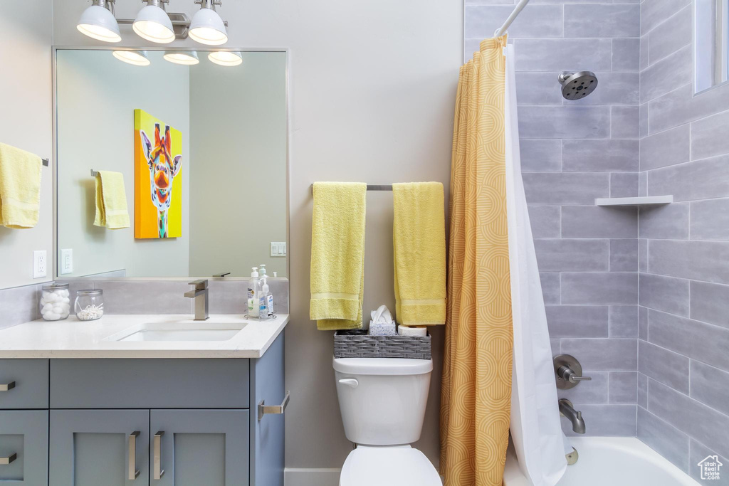 Full bathroom with vanity, toilet, and shower / bath combo